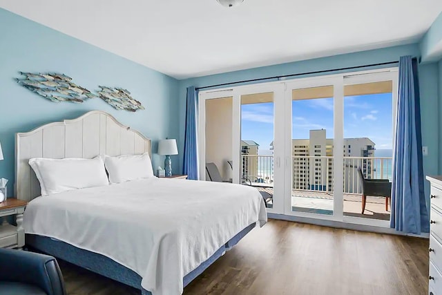 bedroom featuring wood finished floors and access to exterior