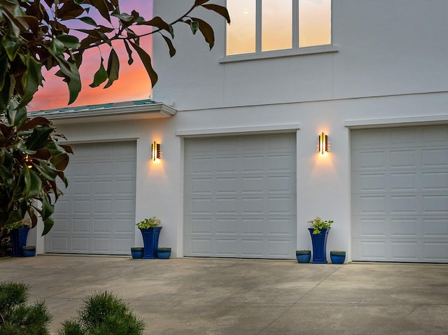 garage featuring concrete driveway