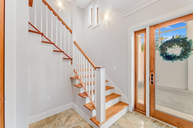 stairs with marble finish floor and baseboards