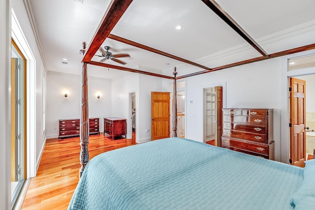 bedroom featuring ensuite bathroom, ornamental molding, light wood-style flooring, and baseboards