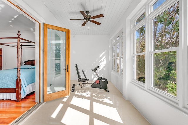 workout room featuring a healthy amount of sunlight, wooden ceiling, and a ceiling fan