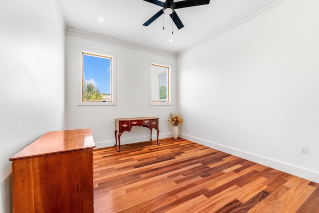 empty room with light wood finished floors, ceiling fan, baseboards, and ornamental molding