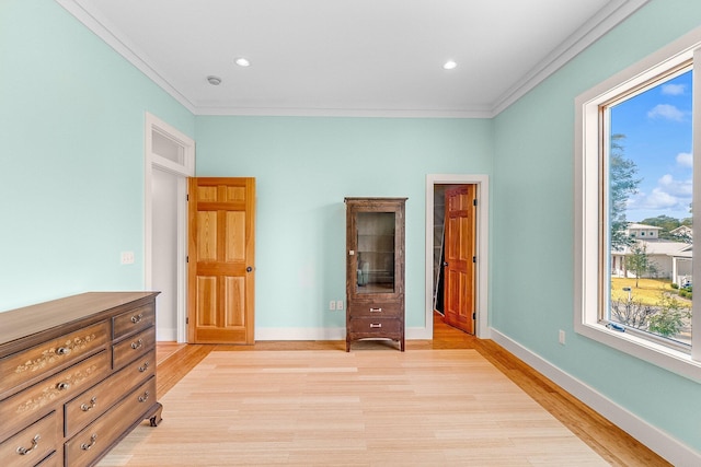 bedroom featuring baseboards, recessed lighting, light wood-style flooring, and crown molding