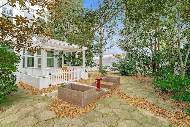 view of patio / terrace with a garden and fence