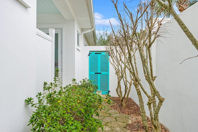 view of side of home with stucco siding and central air condition unit