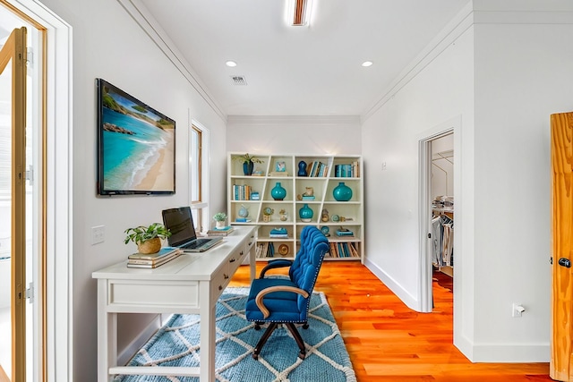 office space with recessed lighting, visible vents, baseboards, light wood-style floors, and ornamental molding