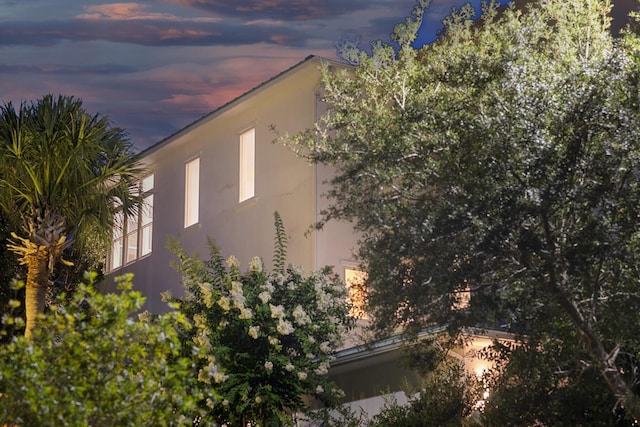 property exterior at dusk with stucco siding