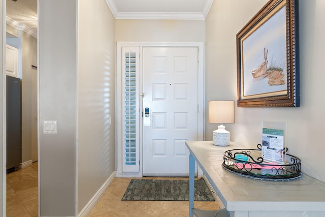 entrance foyer with light tile patterned floors, ornamental molding, and baseboards