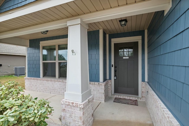 doorway to property with a porch and central air condition unit