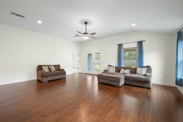 living room featuring lofted ceiling, dark wood-type flooring, french doors, and ceiling fan