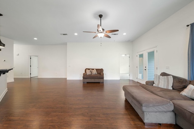 living room featuring ceiling fan, dark hardwood / wood-style flooring, and french doors