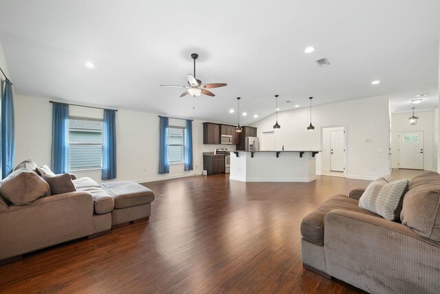 living room with lofted ceiling, dark hardwood / wood-style floors, and ceiling fan