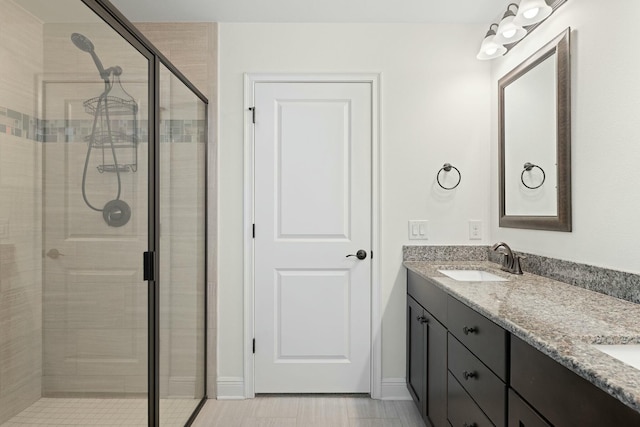 bathroom featuring vanity and a shower with shower door