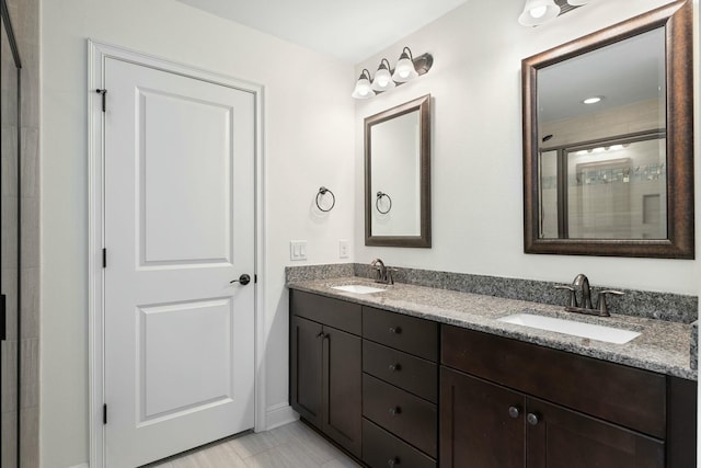 bathroom with walk in shower and vanity