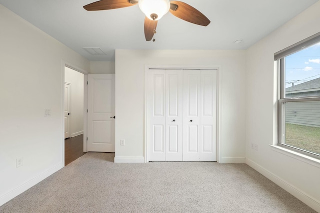 unfurnished bedroom featuring a closet, ceiling fan, and carpet