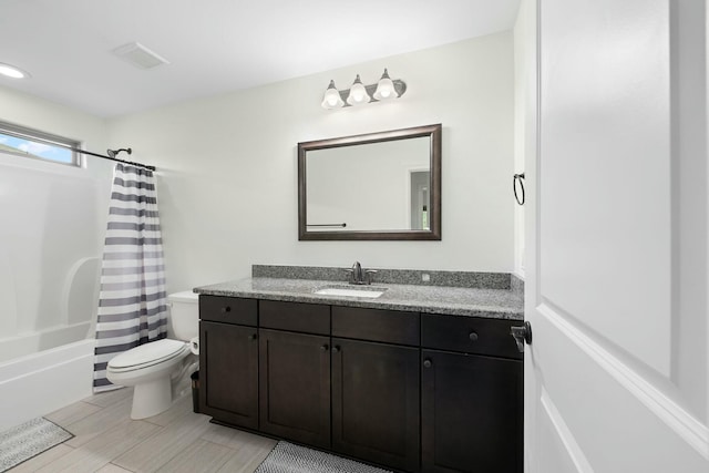 full bathroom featuring shower / bath combination with curtain, vanity, and toilet