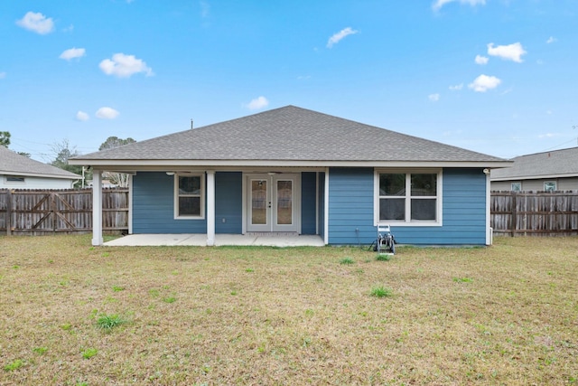 rear view of house featuring a patio area and a lawn