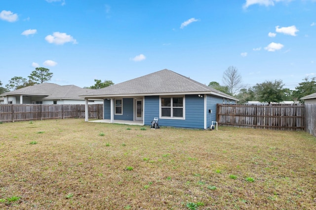 rear view of house with a patio and a lawn