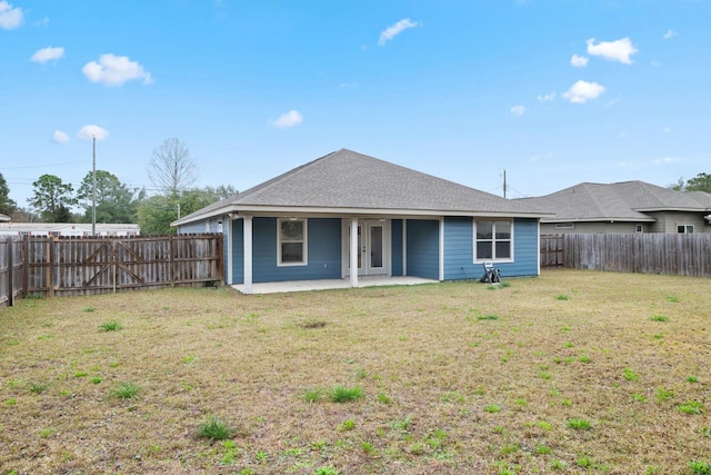 back of property featuring a patio area and a lawn