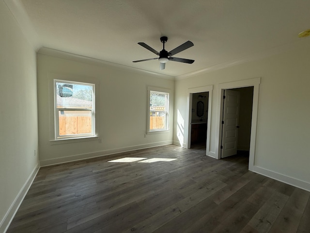 unfurnished bedroom with dark wood-style floors, a ceiling fan, baseboards, and crown molding