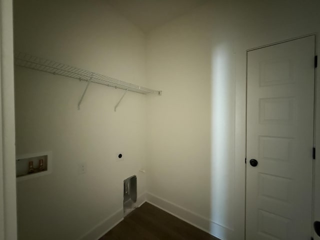 washroom featuring dark wood-style floors, hookup for a washing machine, electric dryer hookup, laundry area, and baseboards