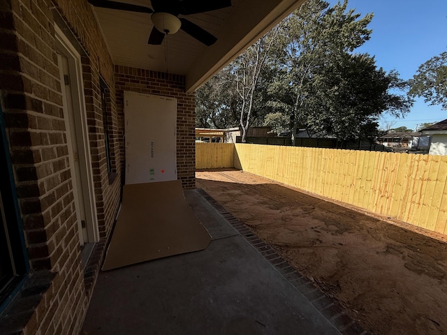 view of patio / terrace with fence and a ceiling fan