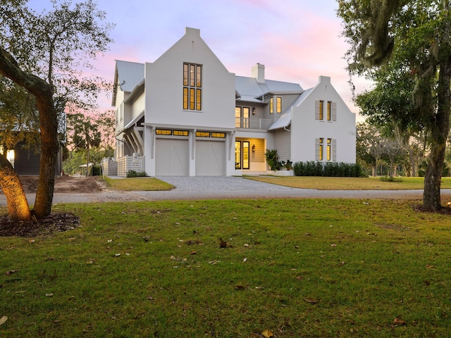 59 Arboleda Dr, Santa Rosa Beach, FL 32459 - view of front of house featuring a chimney, driveway, a lawn, and an attached garage