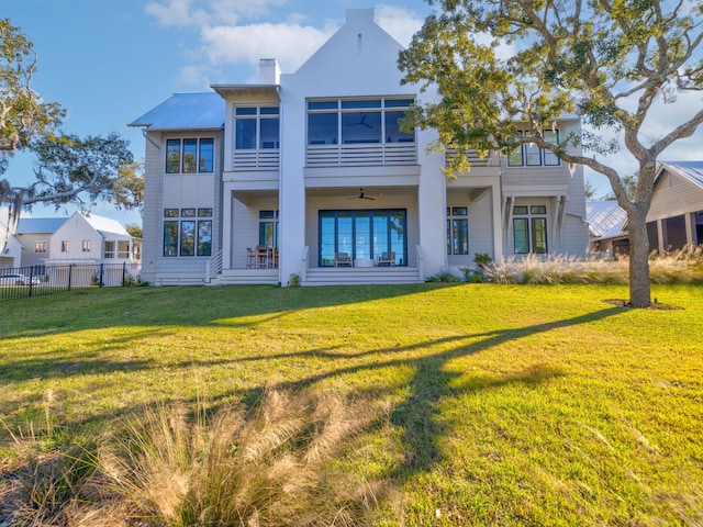 59 Arboleda Dr, Santa Rosa Beach, FL 32459 - rear view of house with a chimney, fence, a balcony, and a lawn