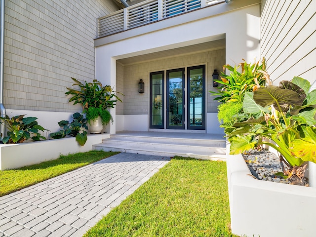 59 Arboleda Dr, Santa Rosa Beach, FL 32459 - view of exterior entry featuring covered porch, a balcony, and stucco siding