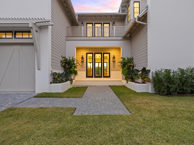 59 Arboleda Dr, Santa Rosa Beach, FL 32459 - property entrance with a lawn, a balcony, and stucco siding