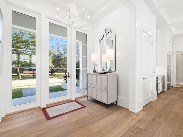 59 Arboleda Dr, Santa Rosa Beach, FL 32459 - entrance foyer with baseboards, ornamental molding, light wood-style flooring, and an inviting chandelier