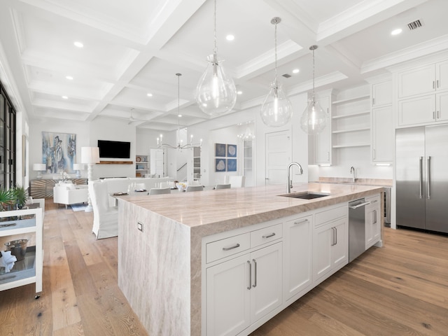 59 Arboleda Dr, Santa Rosa Beach, FL 32459 - kitchen featuring light wood finished floors, open shelves, appliances with stainless steel finishes, a kitchen island with sink, and a sink