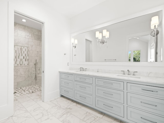 59 Arboleda Dr, Santa Rosa Beach, FL 32459 - full bathroom with double vanity, marble finish floor, tiled shower, and a sink