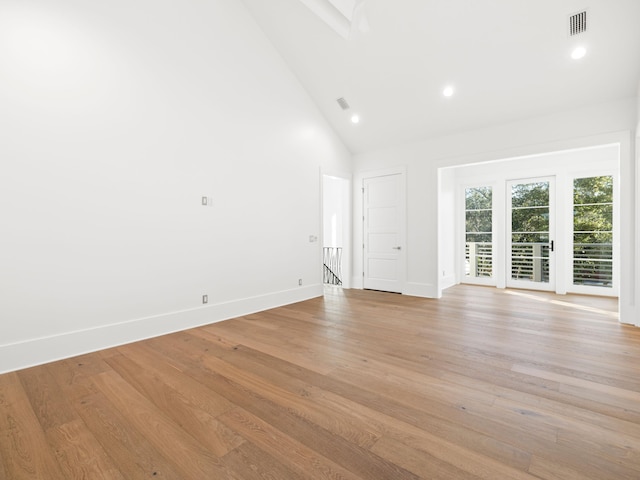 59 Arboleda Dr, Santa Rosa Beach, FL 32459 - unfurnished living room featuring light wood finished floors, baseboards, visible vents, and high vaulted ceiling