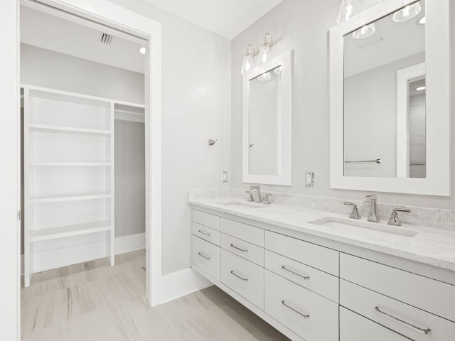 59 Arboleda Dr, Santa Rosa Beach, FL 32459 - full bath featuring double vanity, a spacious closet, baseboards, and a sink