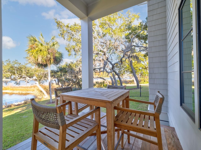 59 Arboleda Dr, Santa Rosa Beach, FL 32459 - deck featuring a water view, outdoor dining area, and a lawn