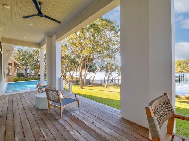 59 Arboleda Dr, Santa Rosa Beach, FL 32459 - wooden deck with a ceiling fan, an outdoor pool, a water view, and a yard