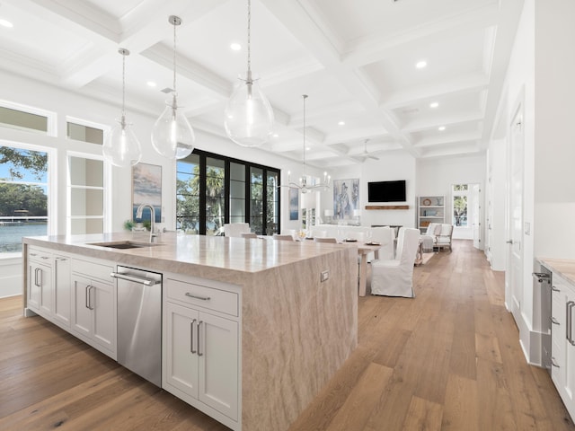 59 Arboleda Dr, Santa Rosa Beach, FL 32459 - kitchen with open floor plan, a sink, an island with sink, light wood-type flooring, and beamed ceiling