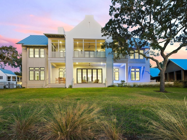 59 Arboleda Dr, Santa Rosa Beach, FL 32459 - rear view of house featuring a balcony, a chimney, a ceiling fan, and a yard