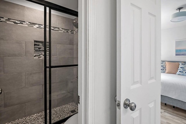 bathroom featuring wood-type flooring and walk in shower