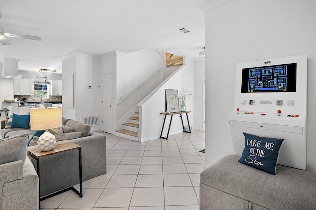 living room with ceiling fan and light tile patterned floors