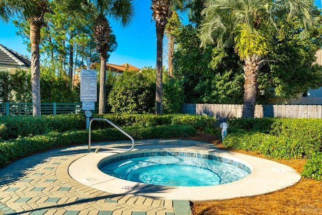 view of swimming pool featuring a hot tub