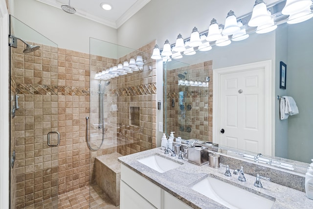 bathroom with double vanity, ornamental molding, a stall shower, and a sink