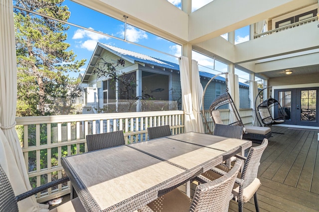 deck with outdoor dining area and french doors