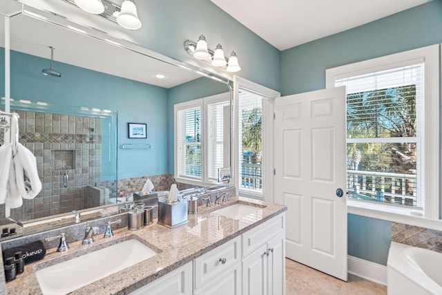 full bathroom with tile patterned flooring, a sink, a shower stall, and baseboards