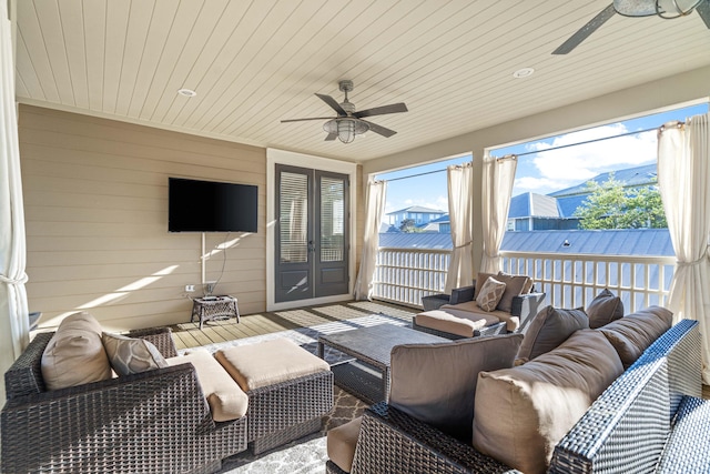 sunroom featuring wooden ceiling and a ceiling fan