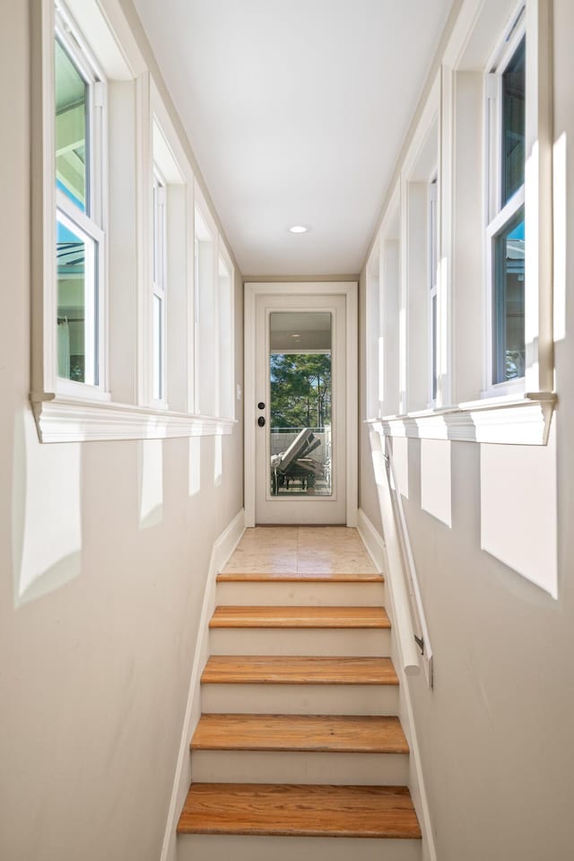 stairs with recessed lighting and baseboards