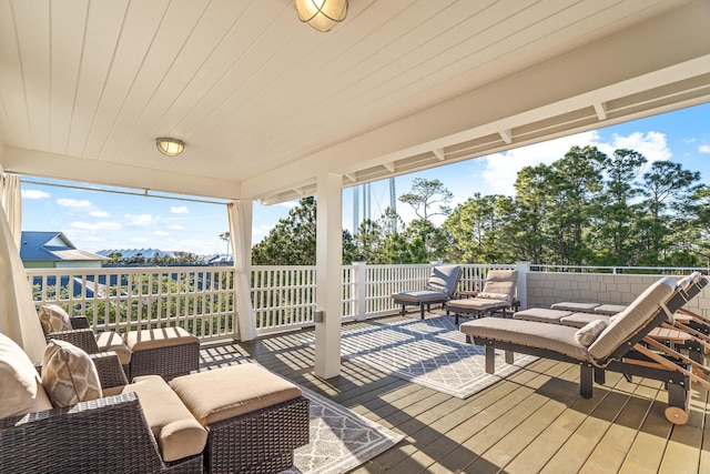 wooden terrace featuring an outdoor living space