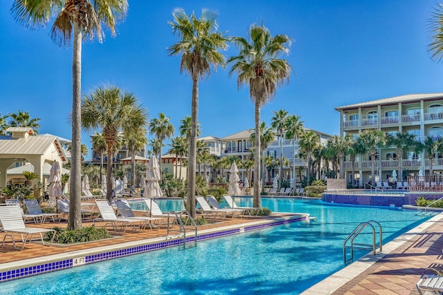 community pool featuring a patio and a residential view