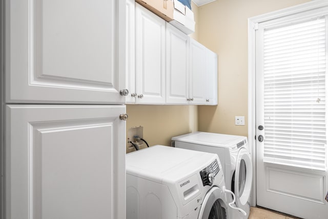 clothes washing area with cabinet space and independent washer and dryer